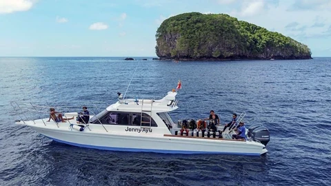 Guests and dive cylinders on the deck of Jenny Ayu