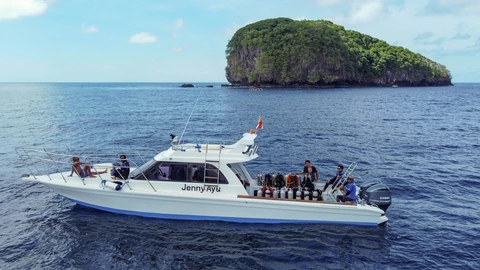 Guests and dive cylinders on the deck of Jenny Ayu